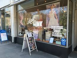 A shop window with an advertising board supplied by signwriter The Sign Supermarket